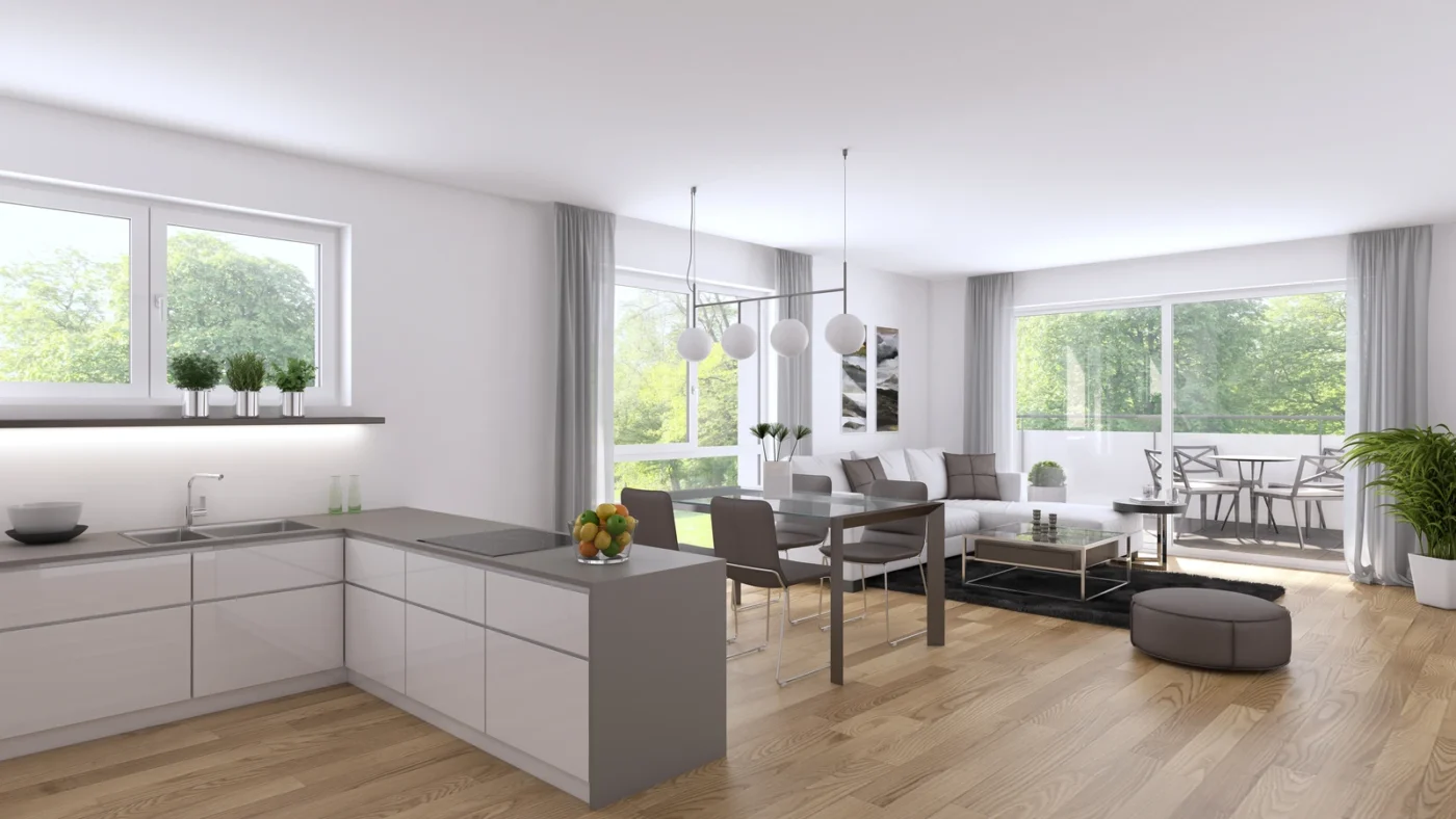 Bronnwiesenweg Rudersberg Eine moderne, offen gestaltete Wohnküche mit weißen Wänden, Holzböden, großen Fenstern mit Blick ins Grüne, minimalistischen Möbeln und Pendelleuchten über dem Esstisch – ein einladendes Neubauobjekt von SCHATZ Wohnbau, ideal für alle, die eine Immobilie in ruhiger Lage kaufen möchten.