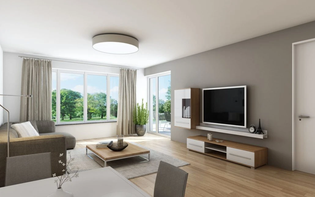 Betreutes Wohnen Schafhofstraße Albershausen Modernes Wohnzimmer mit großen Fenstern, grauem Sofa, an der Wand montiertem Fernseher, weißen und Holzmöbeln, einer Zimmerpflanze und hellem Holzboden. Sonnenlicht durchflutet den Raum dieser Neubauwohnung von SCHATZ Wohnbau, und draußen ist Grün zu sehen.